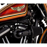 Close-up of a motorcycle with a red and black design and winged emblem.